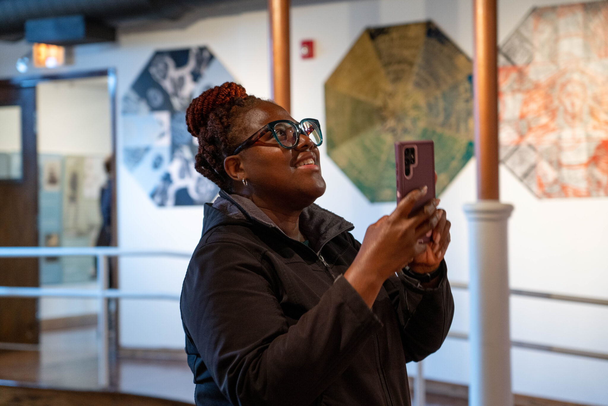 woman taking picture with her phone inside a building during Open House Chicago