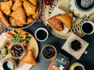 lots of coffee and pastries on a table