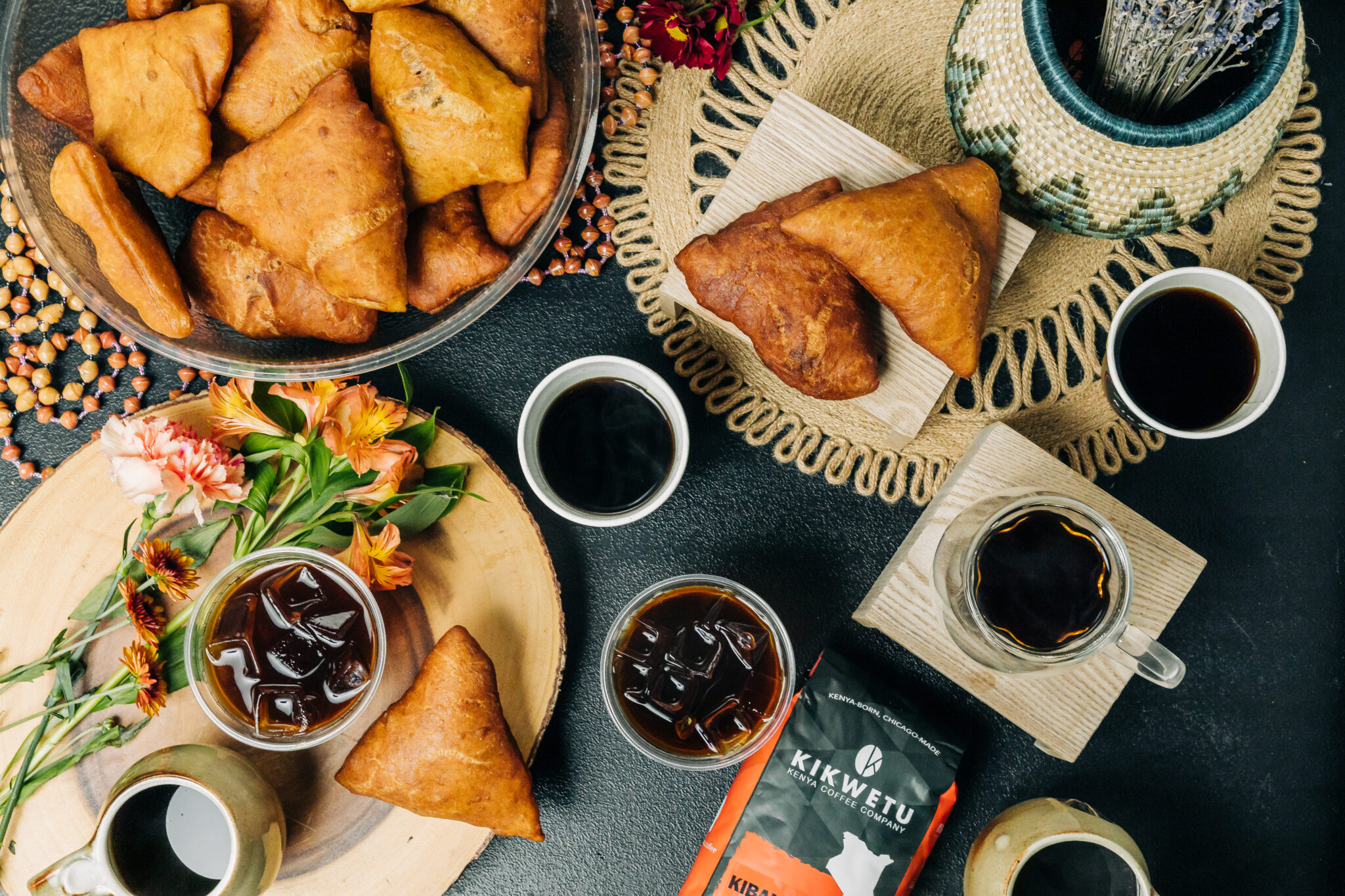 lots of coffee and pastries on a table